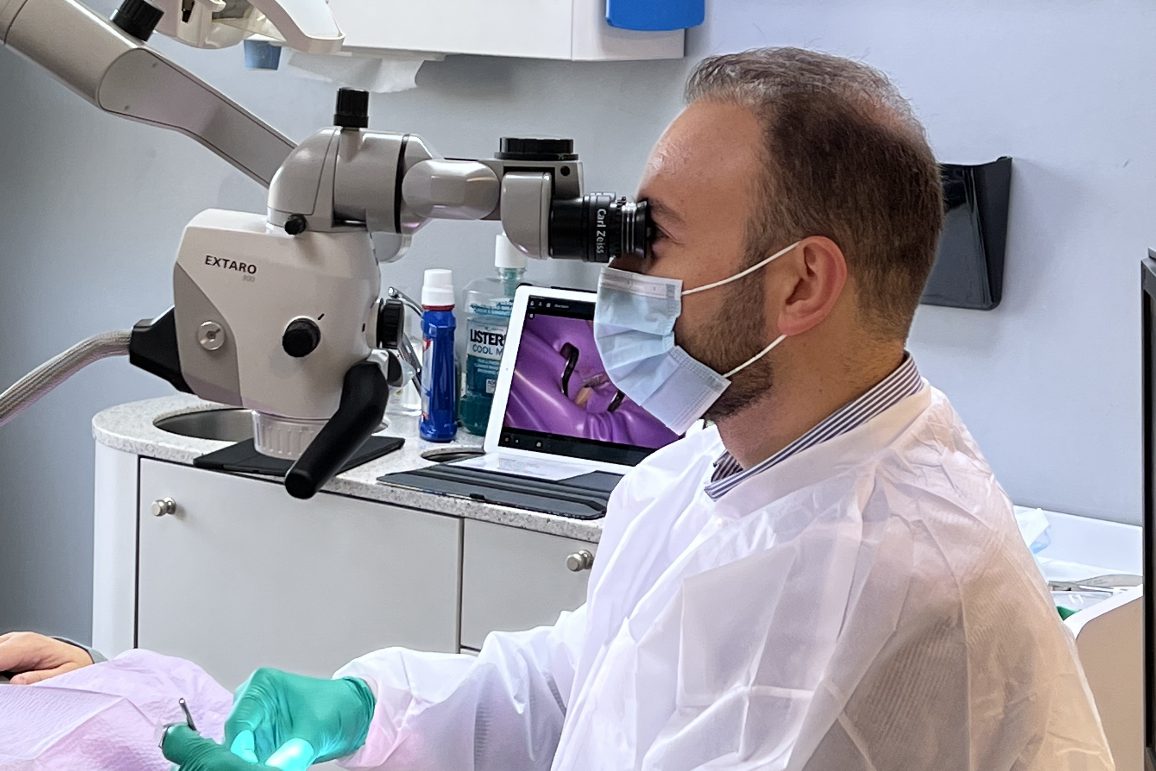 Dr. Nabeeh Jaghab looking through the microscope.